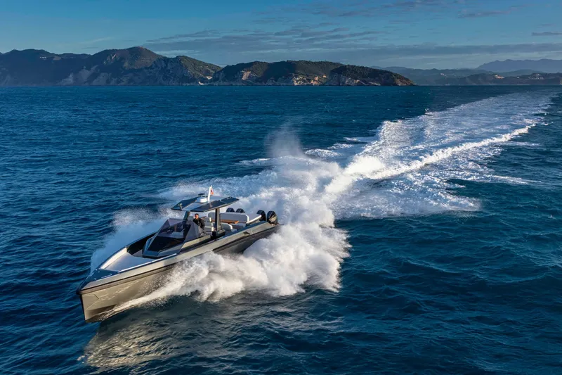 Slide: The Image of 2026 Wally wallytender48X yacht cruising on open sea with scenic coastal backdrop. - 9