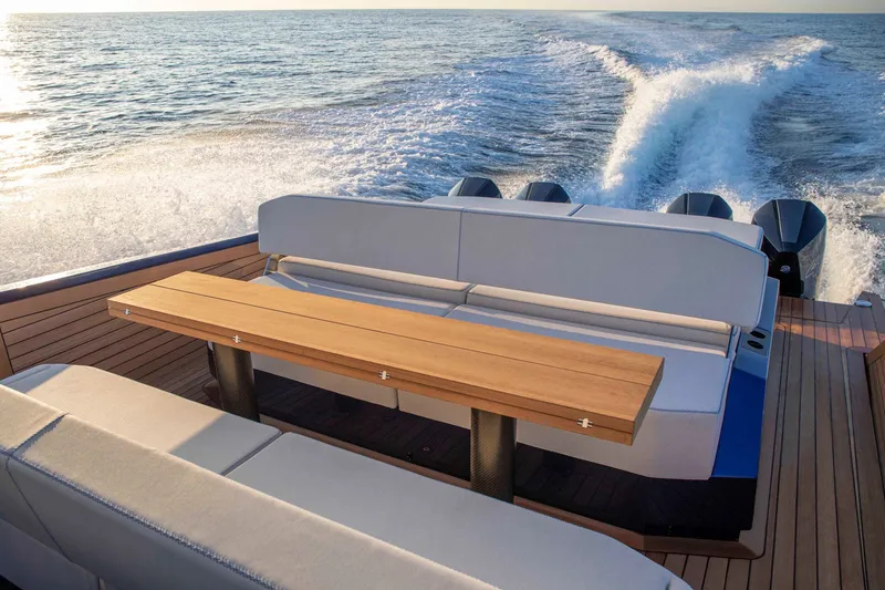 Slide: The Image of Luxurious 2026 Wally wallytender48X yacht cruising on open water, featuring elegant seating and table. - 13