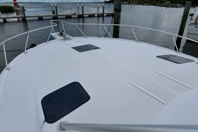 Slide: The Image of 1998 Luhrs 40 Open boat deck with railing, docked by calm waters. - 33