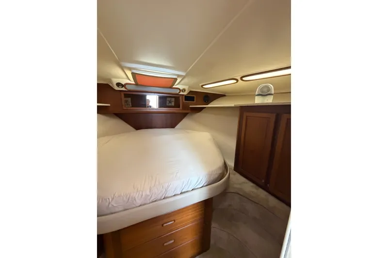 Slide: The Image of Cozy cabin interior of 1998 Luhrs 40 Open boat with wooden cabinetry and bed. - 18
