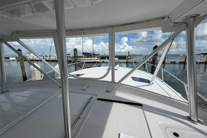Slide: The Image of 1998 Luhrs 40 Open boat docked at marina, clear sky, calm waters. - 25