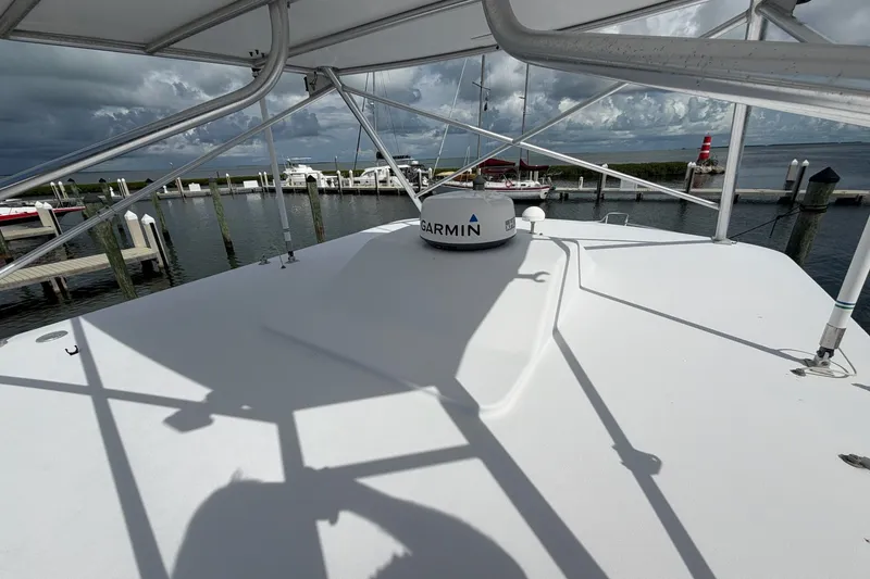 Slide: The Image of 1998 Luhrs 40 Open boat deck with Garmin equipment, docked at marina under cloudy sky. - 31