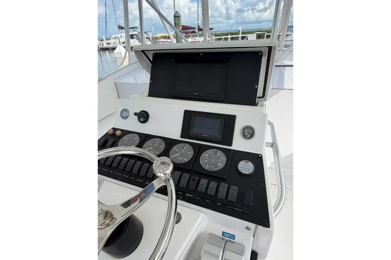 Slide: The Image of Control panel of a 1998 Luhrs 40 Open boat with gauges and steering wheel. - 23