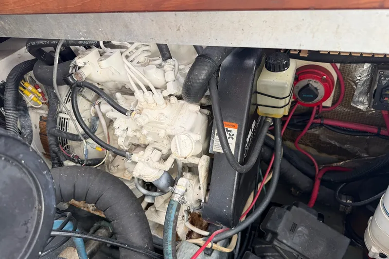 Slide: The Image of Engine compartment of a 1998 Luhrs 40 Open boat, showcasing wiring and components. - 29