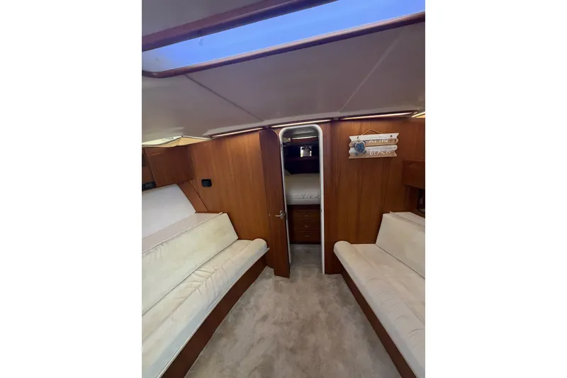 Slide: The Image of Interior of 1998 Luhrs 40 Open yacht with cozy seating and wooden paneling. - 13