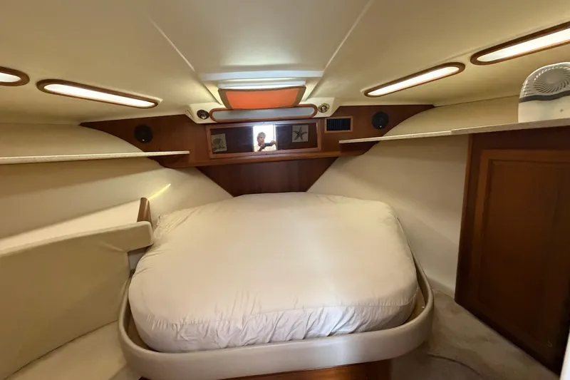 Slide: The Image of 1998 Luhrs 40 Open cabin interior with cozy bed and wooden accents. - 17