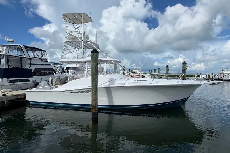 Slide: The Image of 1998 Luhrs 40 Open yacht docked at marina under cloudy sky. - 37