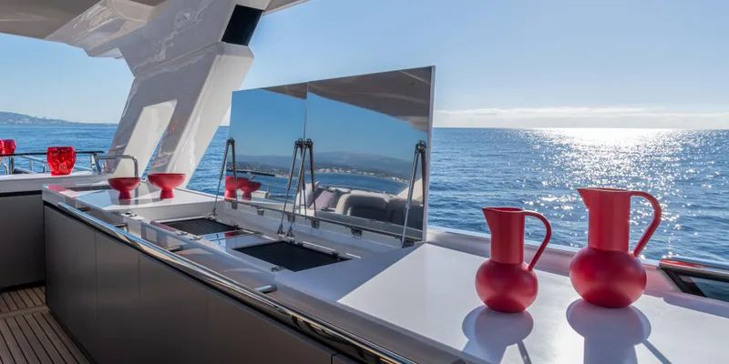 Slide: The Image of Luxury yacht Absolute NAVETTA 75, 2025 model, featuring a sleek outdoor kitchen with ocean view. - 11