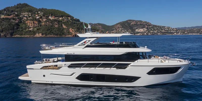 Slide: The Image of Luxury Absolute NAVETTA 75 yacht cruising near scenic coastline, 2025 model. - 4