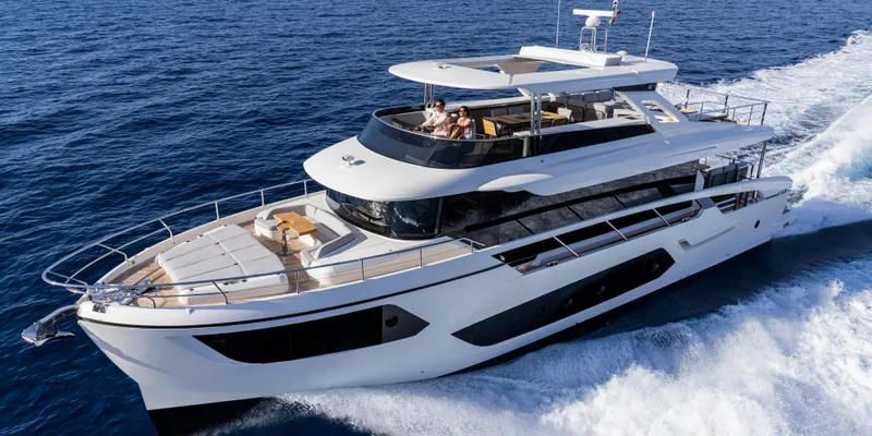 Slide: The Image of Luxurious 2025 Absolute NAVETTA 75 yacht cruising on open sea. - 2