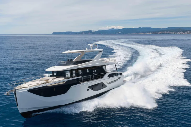 Slide: The Image of Luxury Absolute Navetta 58 yacht cruising on open sea, 2026 model. - 0