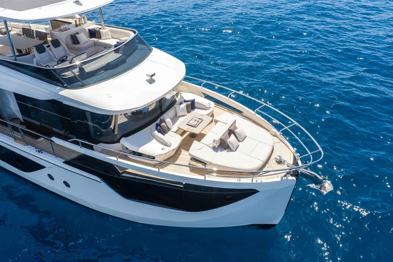 Slide: The Image of Luxurious 2026 Absolute Navetta 58 yacht cruising on clear blue ocean waters. - 6