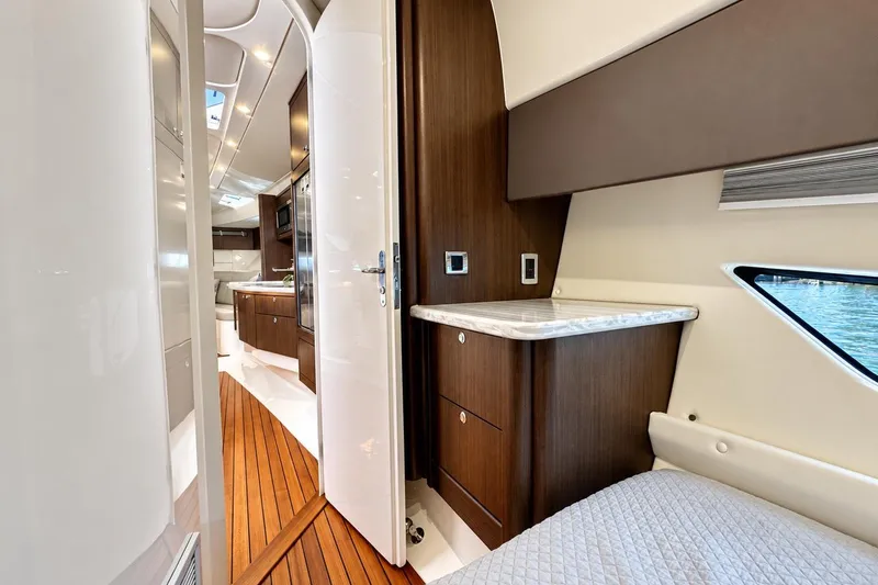 Slide: The Image of Luxurious interior of 2022 Intrepid 477 Evolution yacht with wood accents and modern amenities. - 36