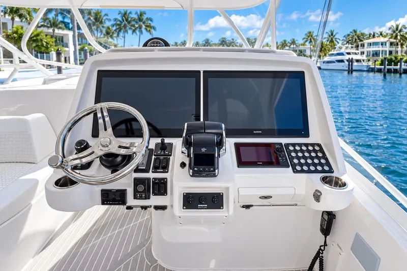 Slide: The Image of 2022 Intrepid 477 Evolution helm with advanced navigation systems and controls, dockside view. - 3