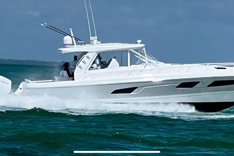 Slide: The Image of 2022 Intrepid 477 Evolution cruising on open water, showcasing sleek design and performance. - 4