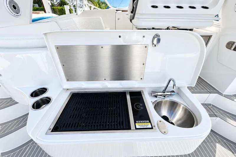 Slide: The Image of Outdoor kitchen on 2022 Intrepid 477 Evolution yacht with grill and sink. - 12