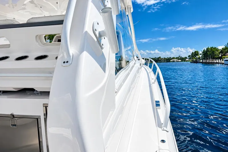 Slide: The Image of 2022 Intrepid 477 Evolution yacht cruising on a sunny day by the waterfront. - 17