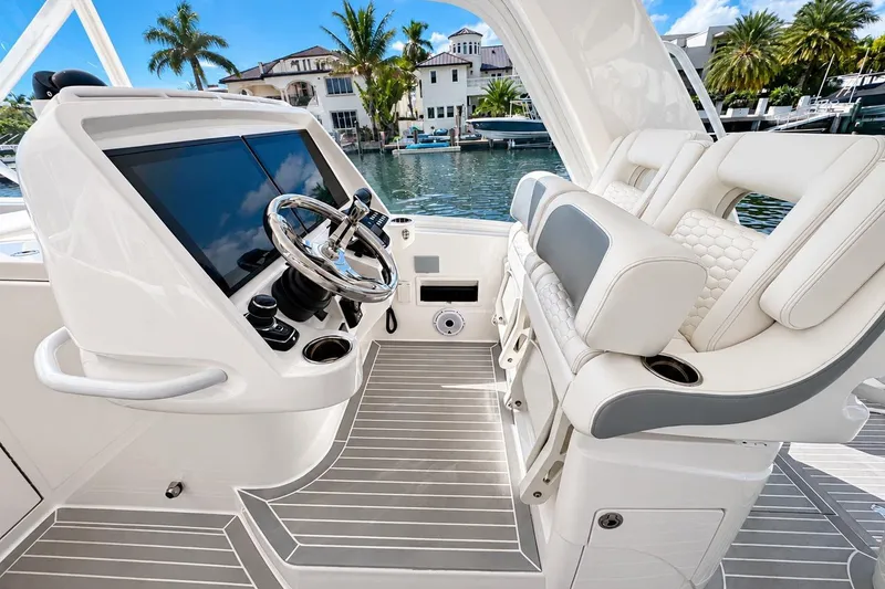 Slide: The Image of 2022 Intrepid 477 Evolution helm with modern controls and luxurious seating. - 21