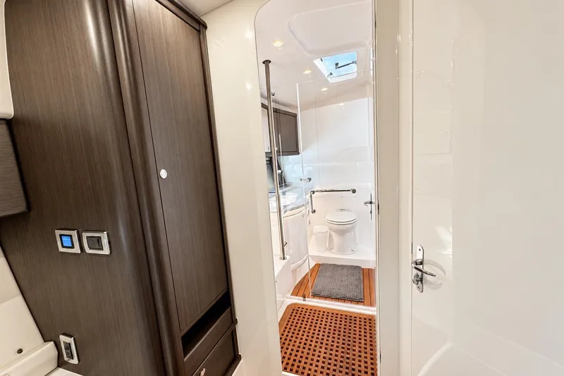 Slide: The Image of Luxurious bathroom interior of 2022 Intrepid 477 Evolution yacht, featuring modern design and amenities. - 35