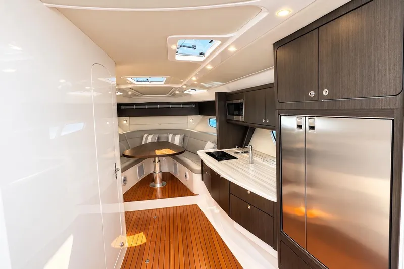 Slide: The Image of Luxurious interior of 2022 Intrepid 477 Evolution yacht with modern kitchen and seating area. - 39