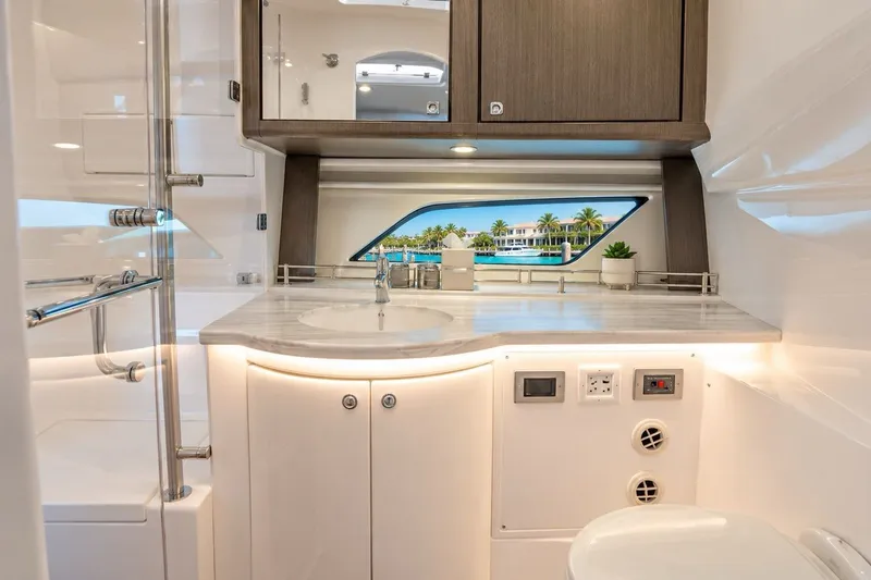 Slide: The Image of Luxurious bathroom interior of 2022 Intrepid 477 Evolution yacht with modern fixtures and ocean view. - 9