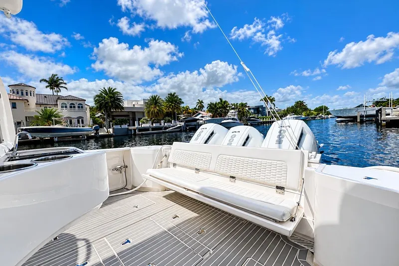 Slide: The Image of 2022 Intrepid 477 Evolution boat with triple engines docked in a scenic marina. - 15