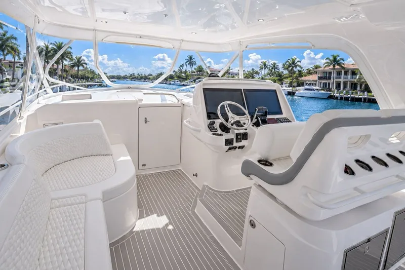 Slide: The Image of Luxurious 2022 Intrepid 477 Evolution yacht cockpit with plush seating and modern controls. - 4