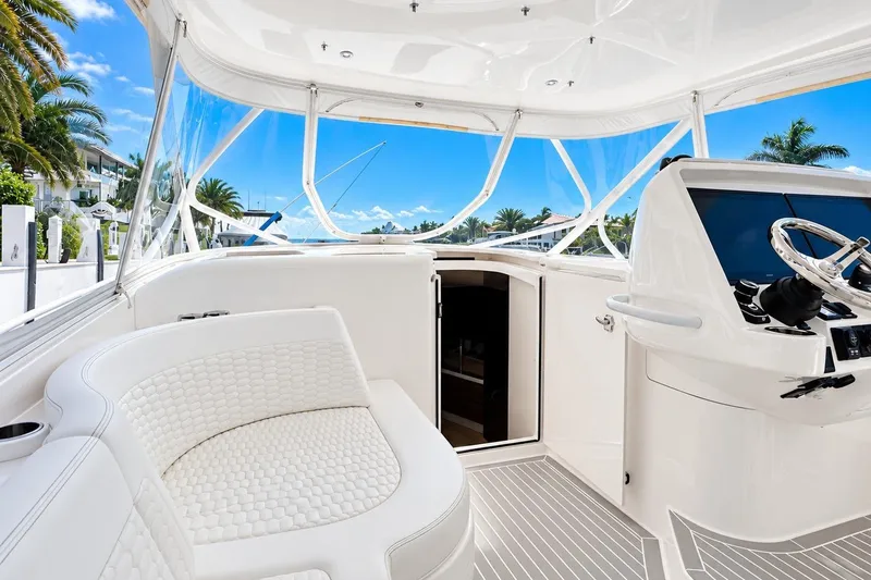 Slide: The Image of Luxurious 2022 Intrepid 477 Evolution yacht interior with sleek helm and plush seating. - 31