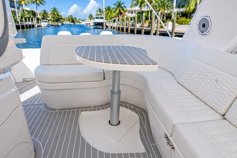 Slide: The Image of Luxurious seating area on 2022 Intrepid 477 Evolution yacht, featuring elegant white upholstery. - 5