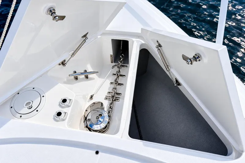 Slide: The Image of Anchor storage compartment on 2022 Intrepid 477 Evolution boat, featuring stainless steel fittings. - 26