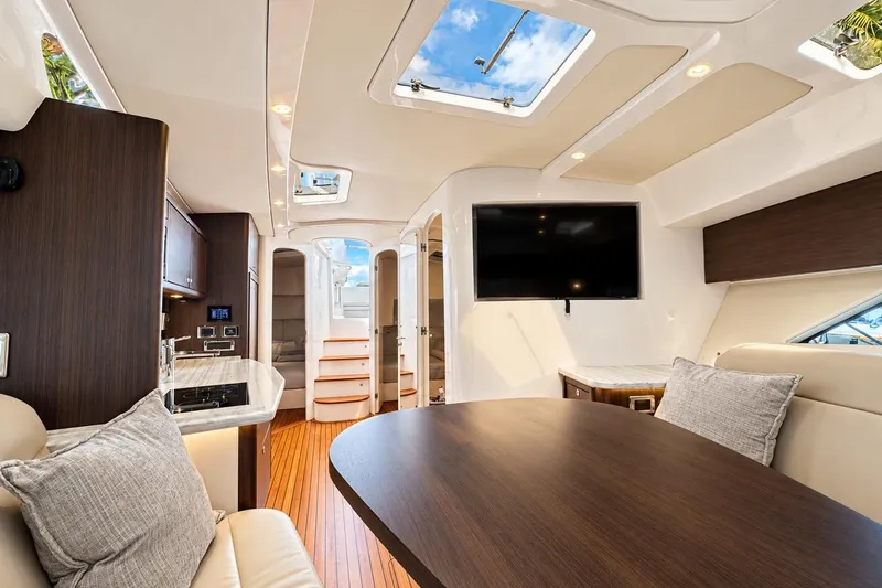 Slide: The Image of Luxurious interior of 2022 Intrepid 477 Evolution yacht with modern furnishings and skylights. - 40