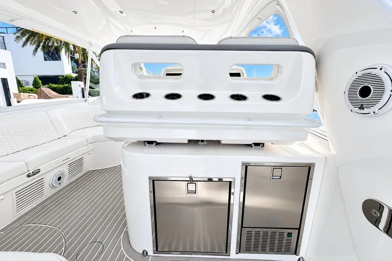 Slide: The Image of 2022 Intrepid 477 Evolution yacht interior with sleek seating and modern amenities. - 13