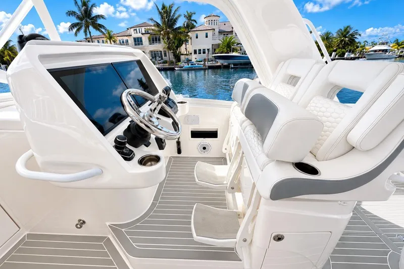Slide: The Image of Luxury helm of 2022 Intrepid 477 Evolution yacht with modern controls and seating. - 23