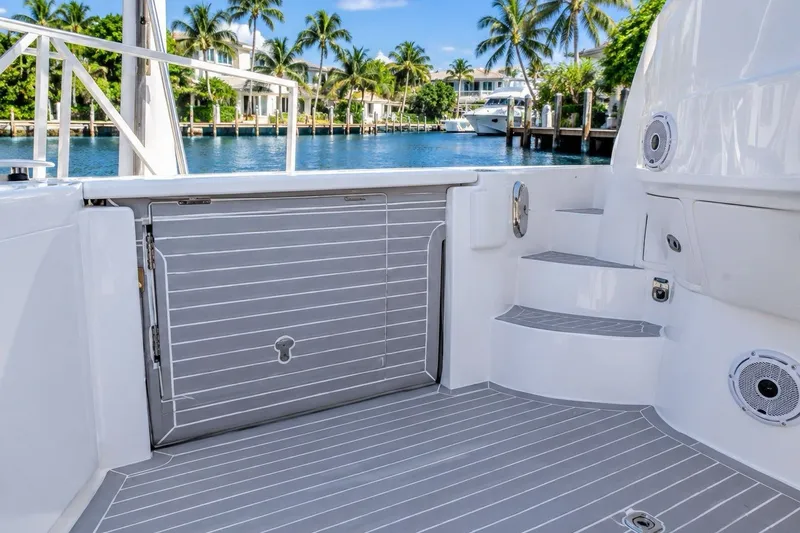 Slide: The Image of 2022 Intrepid 477 Evolution boat deck with sleek design and waterfront view. - 8