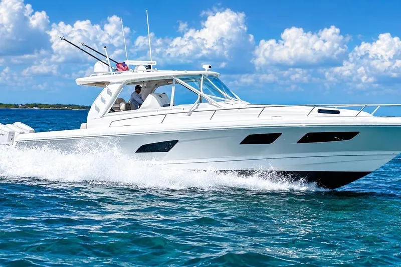 Slide: The Image of 2022 Intrepid 477 Evolution cruising on blue ocean under clear sky. - 3