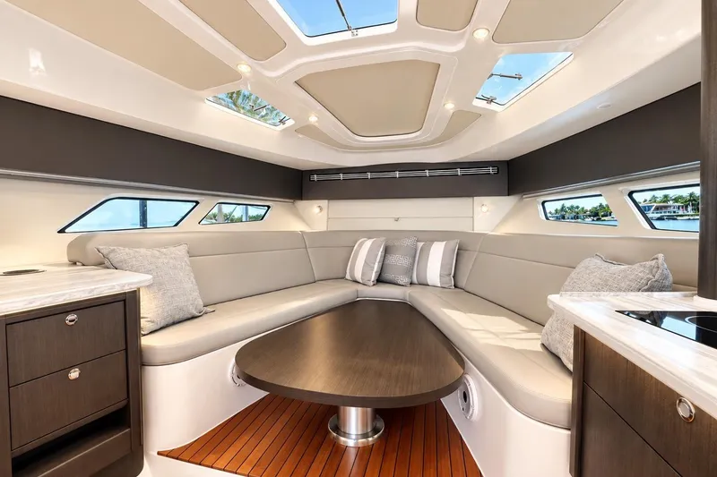 Slide: The Image of Luxurious interior of 2022 Intrepid 477 Evolution yacht with elegant seating and skylights. - 41