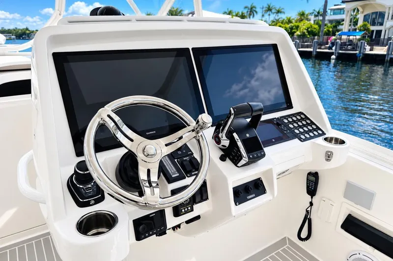 Slide: The Image of 2022 Intrepid 477 Evolution helm with dual screens and modern controls. - 18