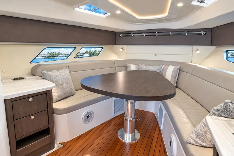Slide: The Image of Luxurious interior of 2022 Intrepid 477 Evolution yacht with elegant seating and wooden table. - 14