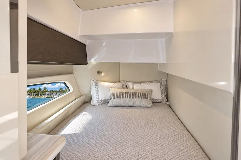 Slide: The Image of Luxurious cabin interior of 2022 Intrepid 477 Evolution yacht with cozy bedding. - 10