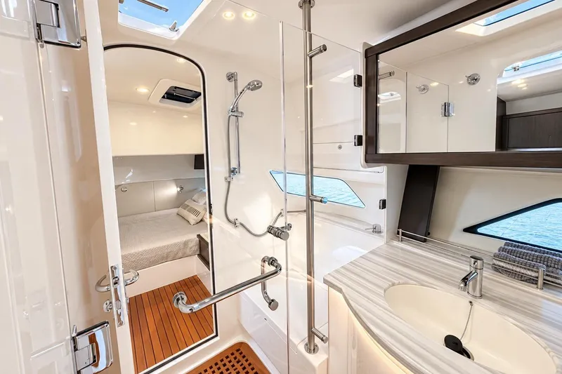 Slide: The Image of Luxurious 2022 Intrepid 477 Evolution yacht interior with modern bathroom and cozy bedroom. - 42