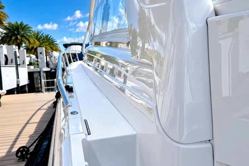 Slide: The Image of 2022 Intrepid 477 Evolution yacht docked, showcasing sleek white exterior and polished railings. - 9