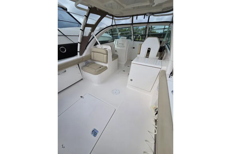 Slide: The Image of 2017 Pursuit DC 265 Dual Console boat interior with seating and storage compartments. - 16