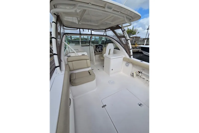Slide: The Image of 2017 Pursuit DC 265 Dual Console boat interior with seating and helm. - 15