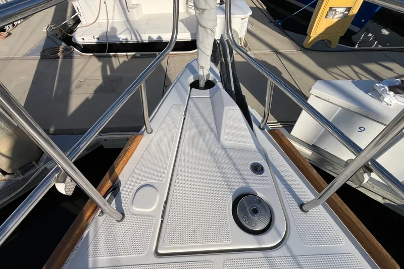 Slide: The Image of Bow of 2013 Bavaria Vision 46 yacht at marina, featuring stainless steel railings. - 4