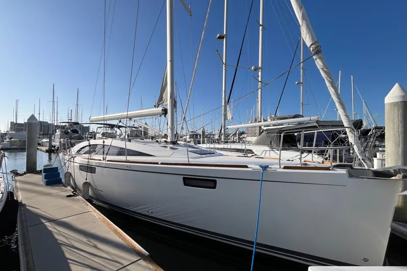 Slide: The Image of 2013 Bavaria Vision 46 sailboat docked at a marina under clear blue skies. - 2