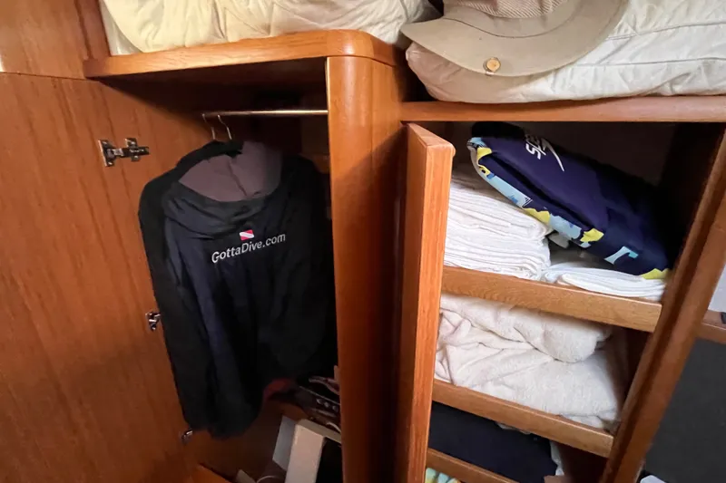 Slide: The Image of Cabin storage in 2013 Bavaria Vision 46 yacht with clothes and towels neatly arranged. - 31