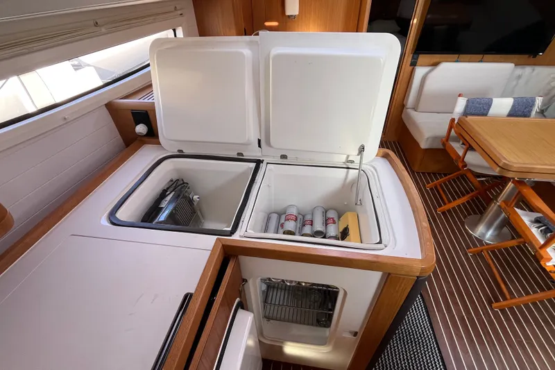 Slide: The Image of Interior of 2013 Bavaria Vision 46 yacht with open fridge and dining area. - 23