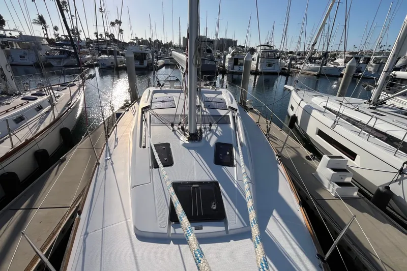 Slide: The Image of Sailboat Bavaria Vision 46, 2013 model, docked in a marina with surrounding yachts. - 3