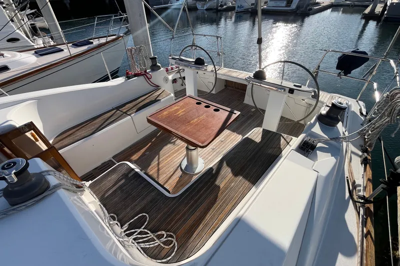 Slide: The Image of Cockpit of 2013 Bavaria Vision 46 sailboat with dual steering wheels and wooden deck. - 9