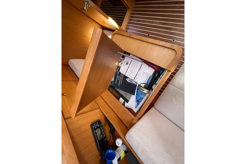 Slide: The Image of Interior storage compartment on a 2013 Bavaria Vision 46 yacht, with documents and items. - 36